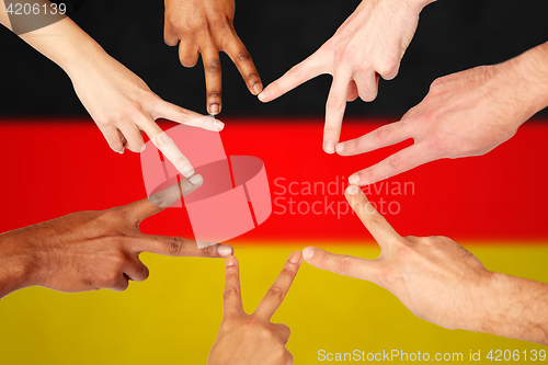 Image of group of international people showing peace sign