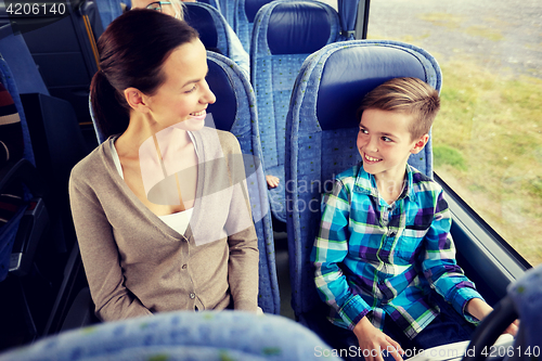 Image of happy family riding in travel bus