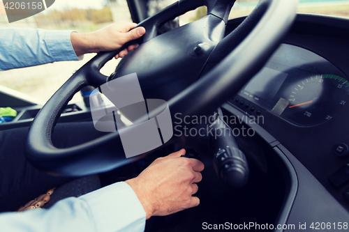 Image of close up of driver starting bus