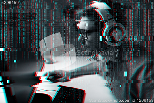 Image of man in headset playing computer video game at home