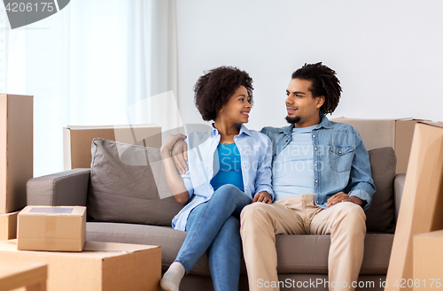 Image of happy couple with boxes moving to new home