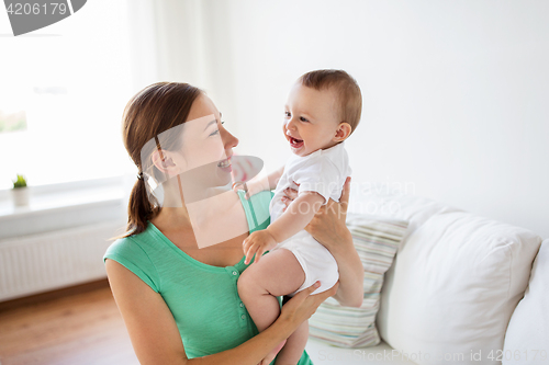Image of happy young mother with little baby at home
