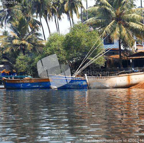 Image of Fishing boats at the pier in palm jungles