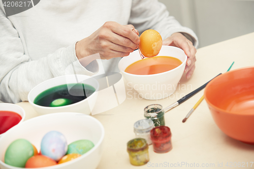 Image of Woman preparing Easter eggs