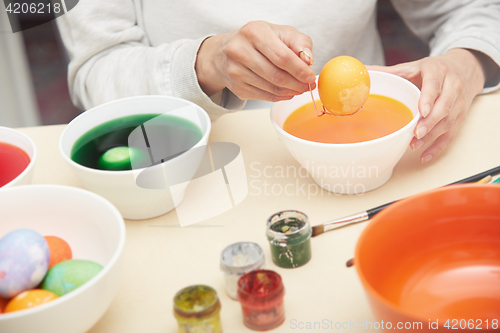 Image of Woman preparing Easter eggs