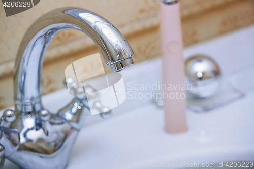 Image of Chrome water tap and sink