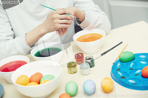 Image of Woman preparing Easter eggs