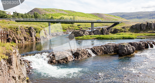 Image of Bridge over a small river and the car on it