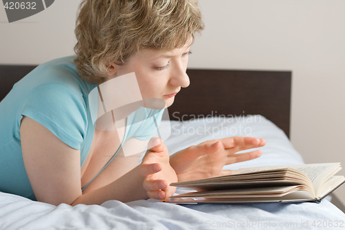 Image of young woman reading a book