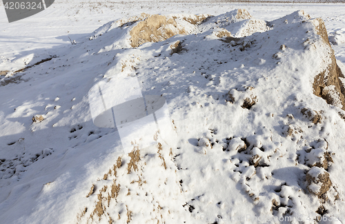 Image of yellow sand under the snow