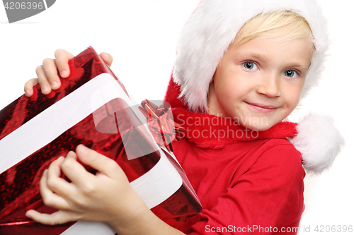 Image of Happy child in the cap of St. Nicholas of packaged gift 