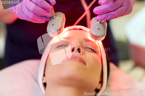 Image of young woman having face microdermabrasion at spa