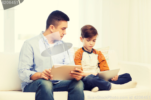 Image of father and son with tablet pc at home