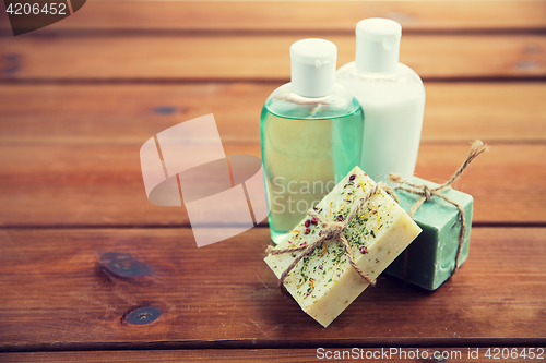 Image of close up of handmade soap bars and lotions on wood