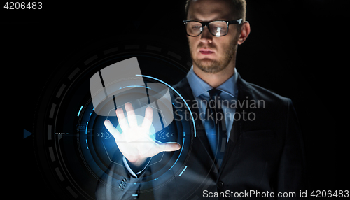Image of businessman touching virtual screen projection