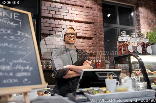 Image of happy seller man or barman at cafe counter