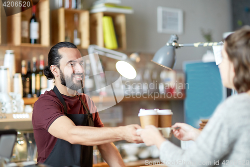 Image of man or waiter serving customer in coffee shop