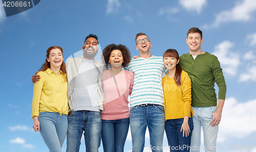 Image of international group of happy people over blue sky