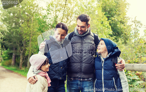 Image of happy family with backpacks hiking