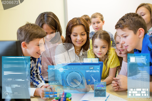 Image of group of kids with teacher and tablet pc at school