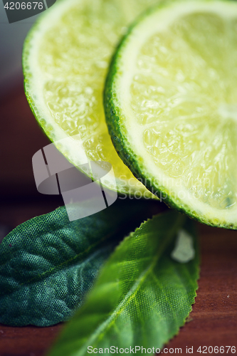 Image of lime slices on wooden table