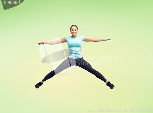 Image of happy smiling sporty young woman jumping in air