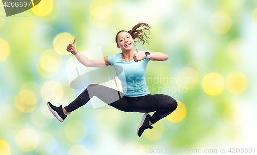 Image of happy smiling sporty young woman jumping in air