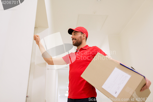 Image of delivery man with parcel box knocking on door