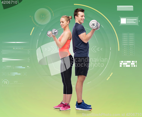 Image of sportive man and woman with dumbbells