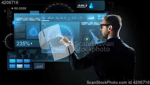 Image of businessman pointing finger to virtual screen