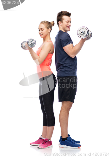 Image of sportive man and woman with dumbbells