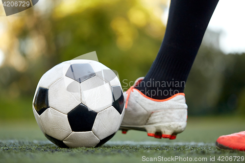 Image of soccer player playing with ball on football field