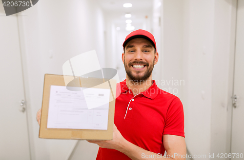 Image of delivery man with parcel box in corridor