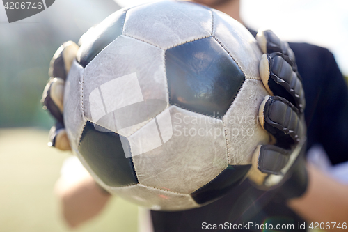 Image of close up of goalkeeper with ball playing football