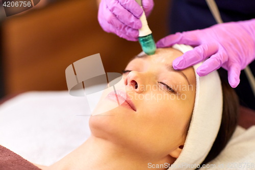 Image of woman having microdermabrasion facial treatment