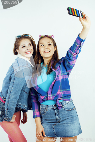 Image of lifestyle people concept: two pretty stylish modern hipster teen girl having fun together, happy smiling making selfie 