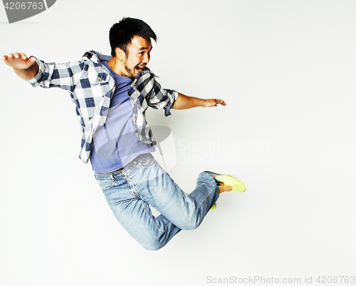 Image of young pretty asian man jumping cheerful against white background