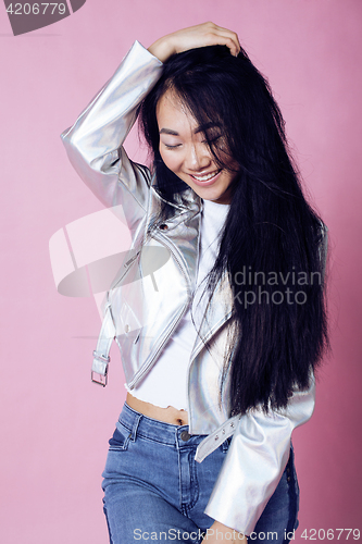 Image of young pretty smiling asian korean girl wearing modern fashion clothers on pink background, lifestyle people concept 