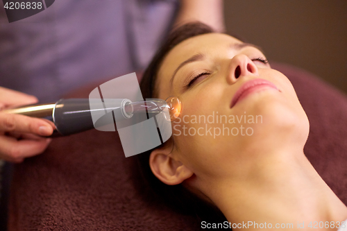 Image of woman having hydradermie facial treatment in spa