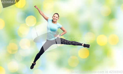 Image of happy smiling sporty young woman jumping in air