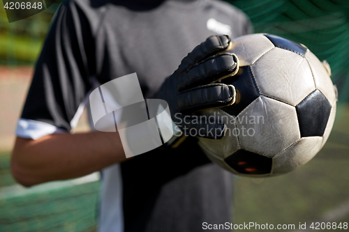 Image of close up of goalkeeper with ball playing football