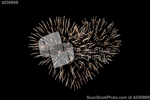 Image of heart shaped fireworks at night