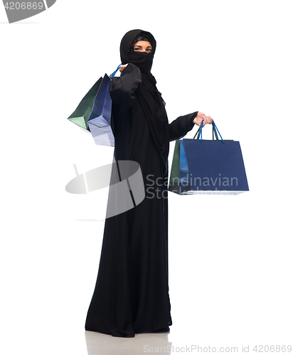 Image of muslim woman in hijab with shopping bags