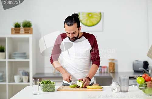 Image of man with blender and fruit cooking at home kitchen