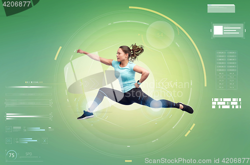 Image of happy sporty young woman jumping in fighting pose