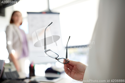 Image of businessman with glasses at presentation in office