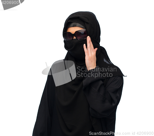 Image of muslim woman in hijab and sunglasses over white