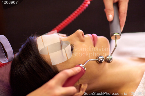 Image of woman having hydradermie facial treatment in spa