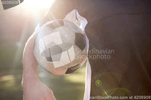 Image of close up of soccer player with ball on field