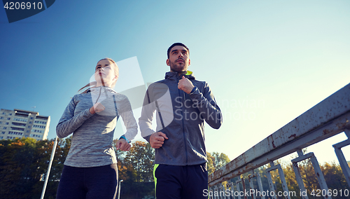 Image of couple running outdoors